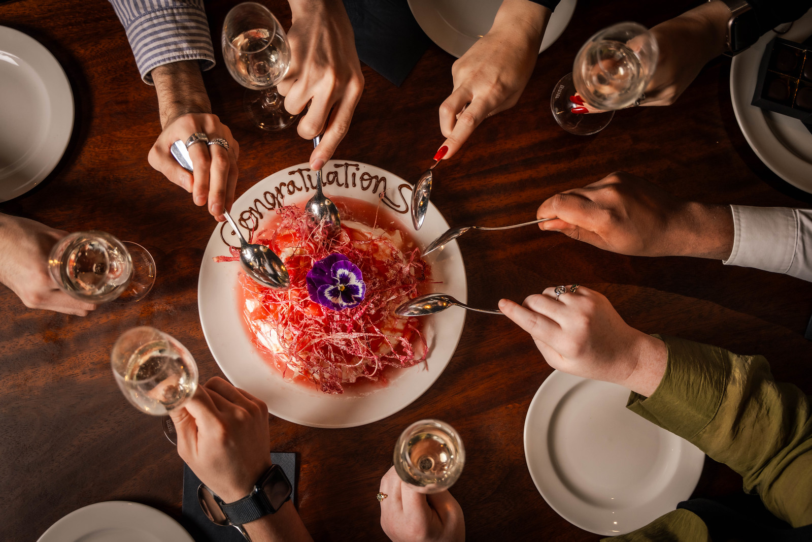 Proper Celebrations at Hawkmoor Dublin 3 An overhead shot of a summer dessert, with5 friends reaching out with spoons for a scoop