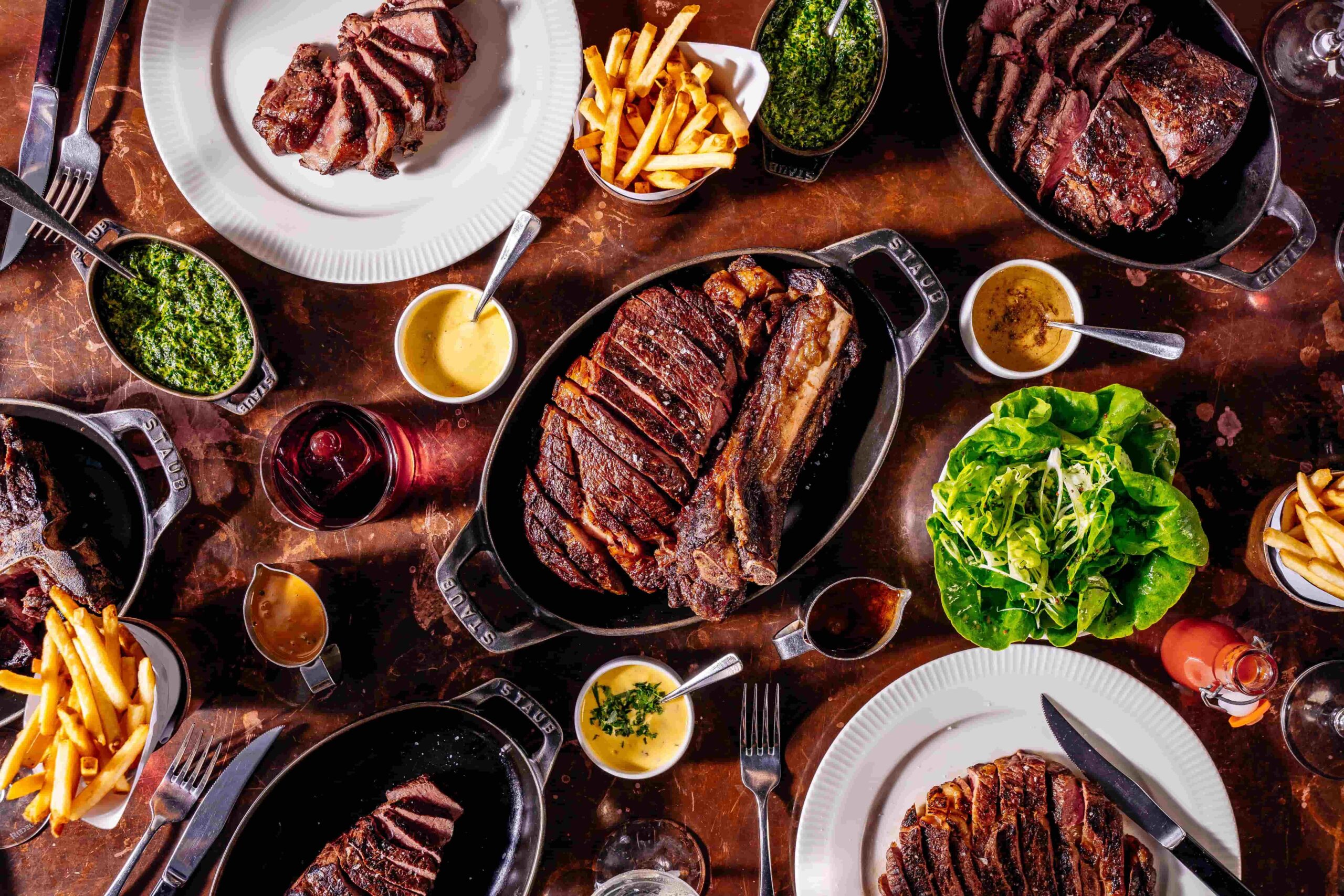 Proper Celebrations at Hawkmoor Dublin 19 Sharing steaks with sides on a bronze table